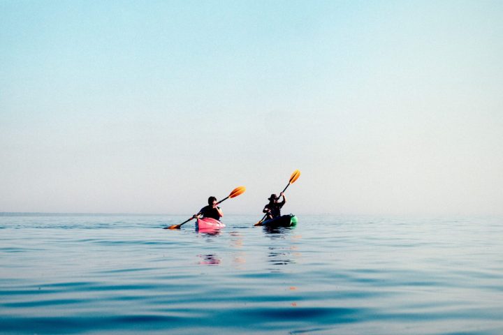 a group of people riding skis on a body of water